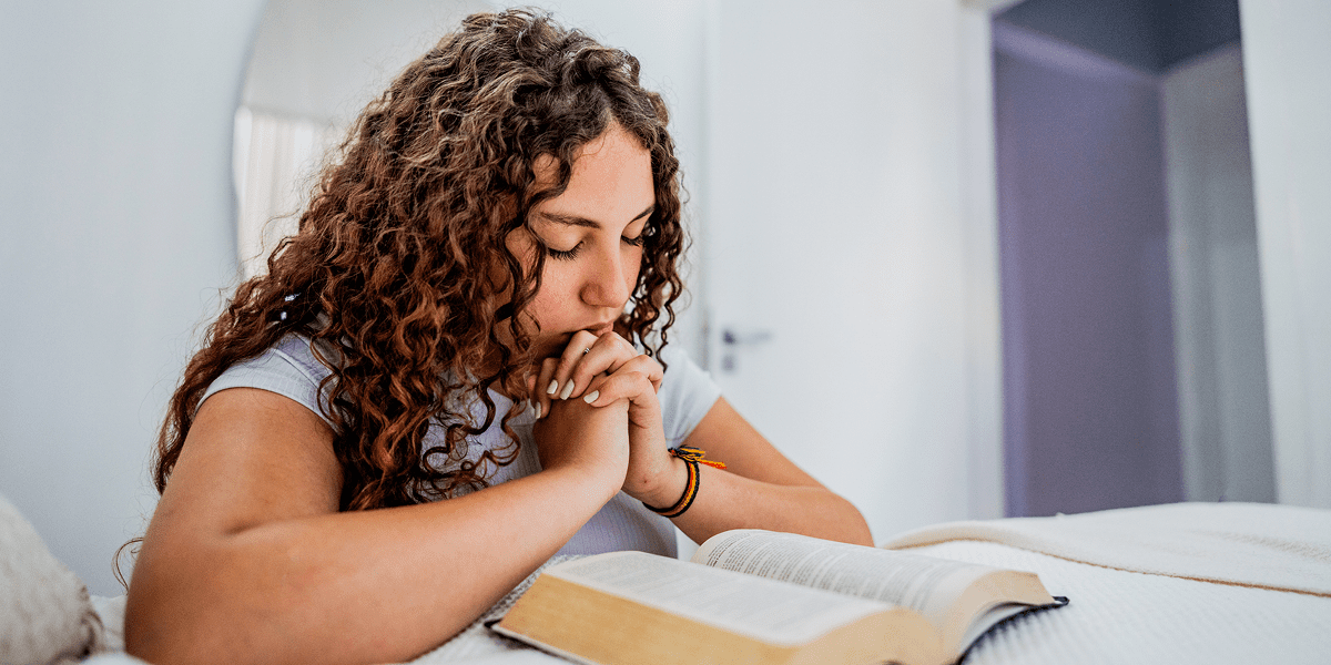 Person deep in prayer at home