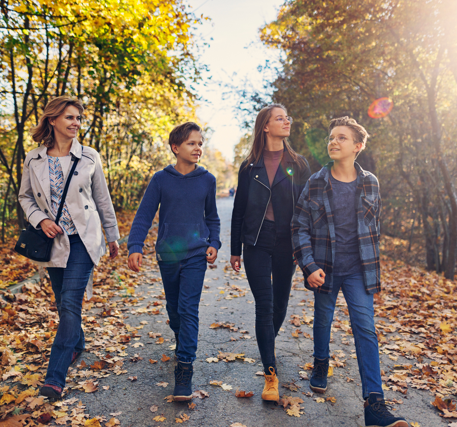 Happy family walking through fall scenery