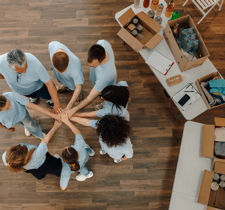 Volunteers joining hands in a circle