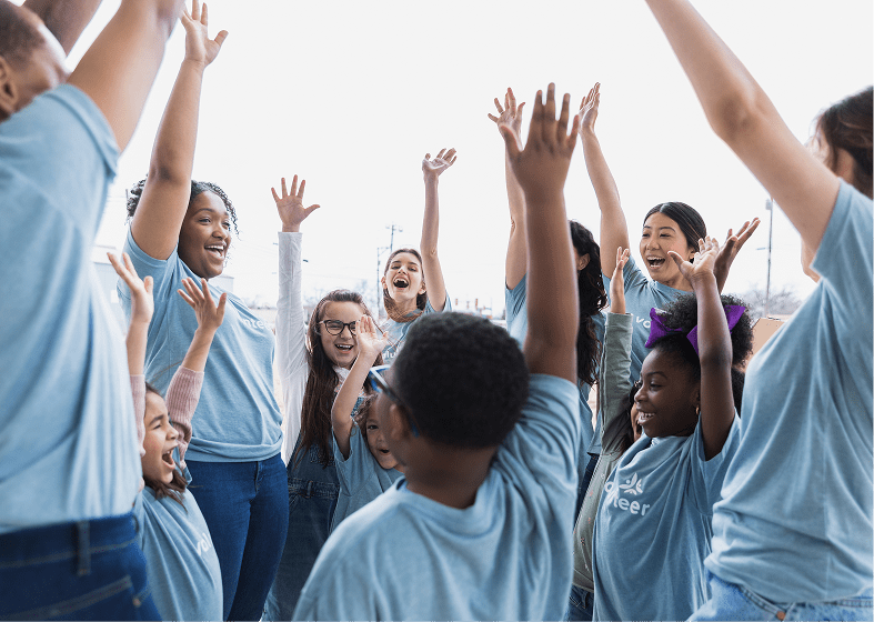 Diverse children raising their hands