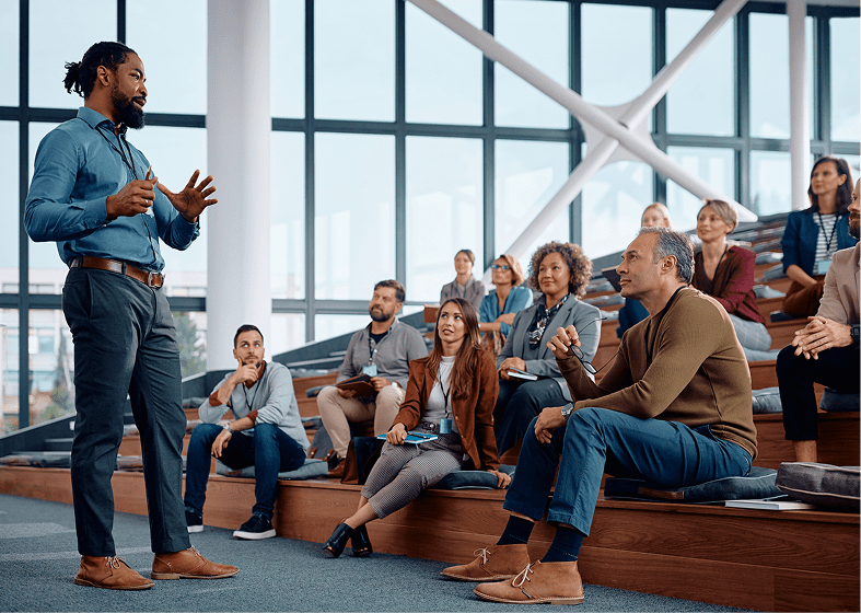 Speaker addressing attentive audience in modern space