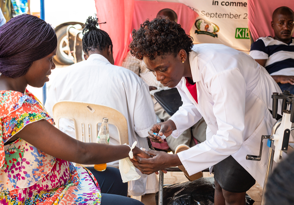 Healthcare worker assisting patient outdoors